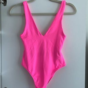 Neon pink body suit